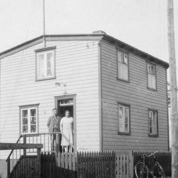 6 - Líklegt þykir að þetta sé húsið Lundargata 5 og í dyrunum sé Halldór Friðjónsson, ritstjóri Alþýðumannsins og eiginkona hans, Álfheiður Einarsdóttir frá Saurbæ. Sonur hennar var Jón Norðfjörð, leikari og bæjargjaldkeri á Akureyri og er myndin úr albúmi sem var í hans eigu. Halldór var bróðir Erlings Friðjónssonar sem lengi var í bæjarstjórn og kaupfélagsstjóri Kaupfélags Verkamanna. Þeir sem kunna að búa yfir meiri upplýsingum um myndina vinsamlega hafi samband við Minjasafnið á Akureyri, á netfangið hg@minjasafnid.is - Minjasafnið á Akureyri / Mynd 300 - 113