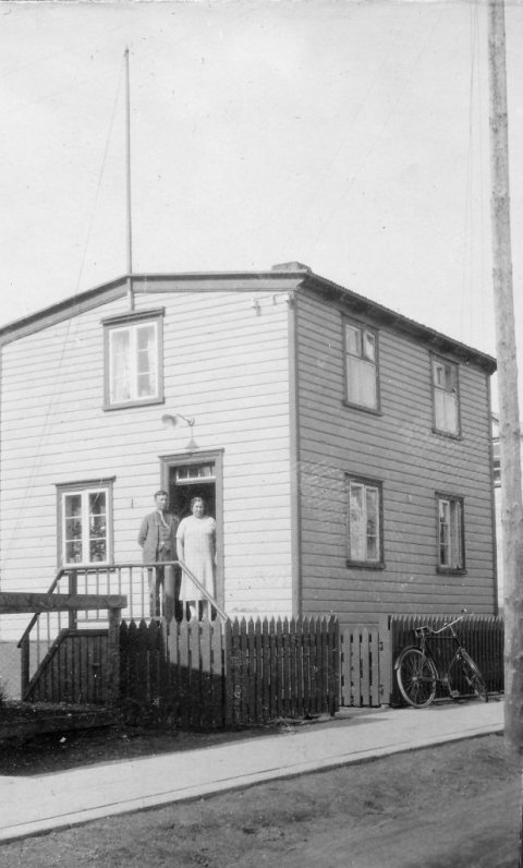 6 - Líklegt þykir að þetta sé húsið Lundargata 5 og í dyrunum sé Halldór Friðjónsson, ritstjóri Alþýðumannsins og eiginkona hans, Álfheiður Einarsdóttir frá Saurbæ. Sonur hennar var Jón Norðfjörð, leikari og bæjargjaldkeri á Akureyri og er myndin úr albúmi sem var í hans eigu. Halldór var bróðir Erlings Friðjónssonar sem lengi var í bæjarstjórn og kaupfélagsstjóri Kaupfélags Verkamanna. Þeir sem kunna að búa yfir meiri upplýsingum um myndina vinsamlega hafi samband við Minjasafnið á Akureyri, á netfangið hg@minjasafnid.is - Minjasafnið á Akureyri / Mynd 300 - 113